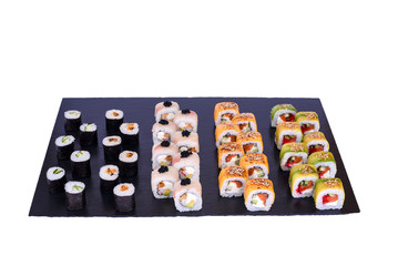 sushi set Omori rolls with fresh ingredients on black stone isolated on white background. Sushi menu. Japanese food.