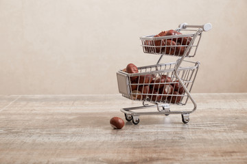 fresh chestnuts in a basket on an old wooden table