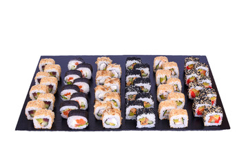 sushi set spicy mix rolls with fresh ingredients on black stone isolated on white background. Sushi menu. Japanese food.
