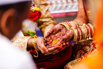 Traditional indian wedding ceremony, groom holding hand in bride hand