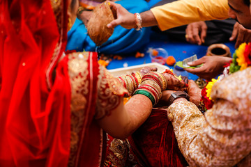 Fototapeta na wymiar Traditional indian wedding ceremony, groom holding hand in bride hand