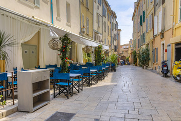 Street with empty restaurant  and terrace Saint Tropez