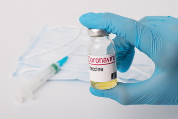 Medical worker holding small bottle that can save huge amount of lives. Concept of inventing coronavirus vaccine
