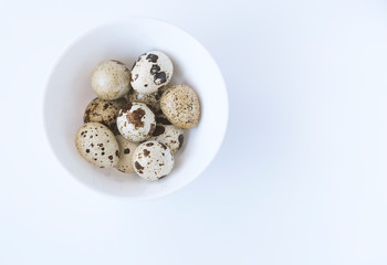 quail eggs in a basket, shot on a white background