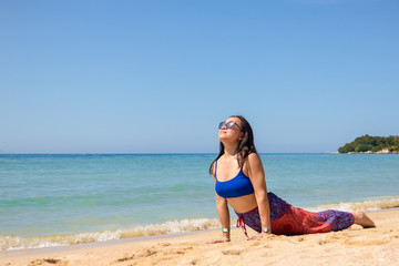 Asian Thai woman practicing yoga in Haad Yao West beach, Koh Phangan island, Thailand