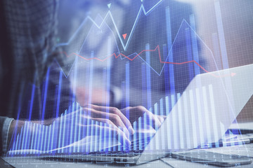 Double exposure of market chart with man working on computer on background. Concept of financial analysis.