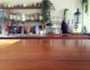 Obraz premium wood table on blur of cafe, coffee shop, bar, resturant, background - can used for display or montage your products