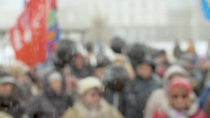 Blurry crowd on protest rally in Moscow with flags and banners. Russian people protesting against corrupt government, the destruction of parks and ancient buildings.