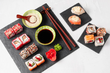 Japanese cuisine. Assorted sushi maki gunkan roll on white table