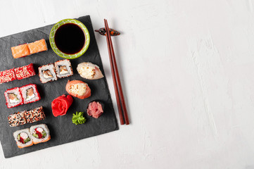 Japanese cuisine. Assorted sushi maki gunkan roll on white table