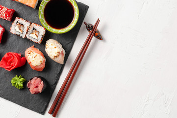Japanese cuisine. Assorted sushi maki gunkan roll on white table
