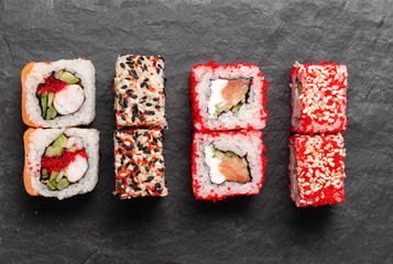 Japanese cuisine. Assorted sushi maki gunkan roll on white table