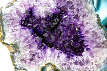 Beautiful Amethyst Purple crystal gemstone with agate on the edge closeup