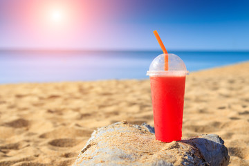 Watermelon juice  with Straw in glass on sand beach at Phuket  Thailand . summer concept 