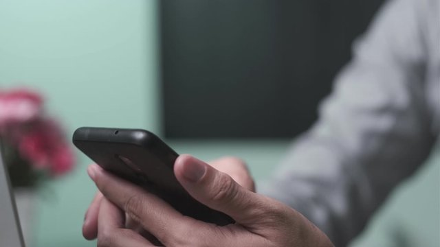 Close-up businessman using smartphone typing text message for connection business partner. Technology concept