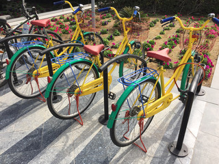 Multi coloured bicycles in a bike rack