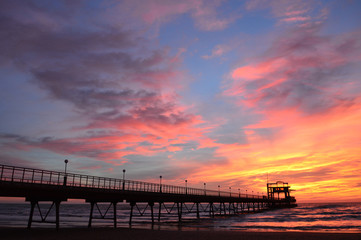 Naklejka na ściany i meble sunset on the sea pier