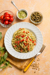 spaghetti with pesto sauce tomatoes fres and capers