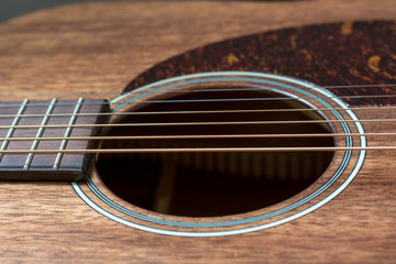 Obraz premium Strings of a brown wooden guitar a close up