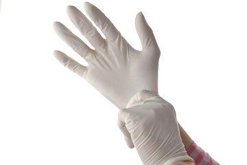Woman's hands putting on surgical gloves-isolation over white background with clipping path.
