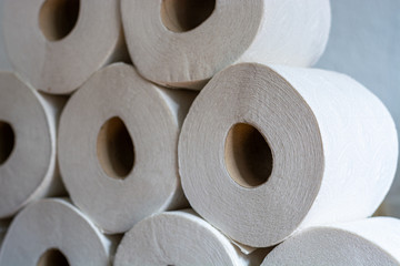 Piled up toilet paper rolls close up from the side