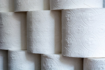 Piled up toilet paper rolls close up from the side
