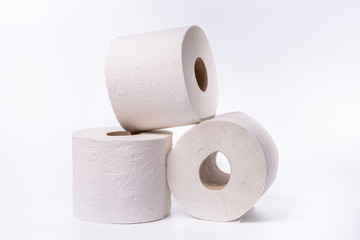 Three toilet paper rolls piled up on white background