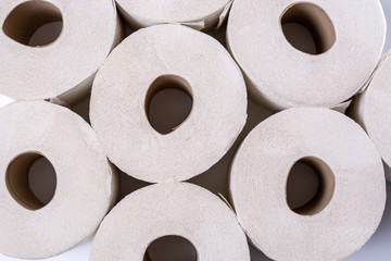 Piled up toilet paper rolls close up from above