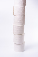 Lots of toilet paper rolls stacked on white background