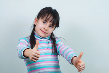 Portrait of a cheerful child with long hair and a striped sweater. girl fooling around