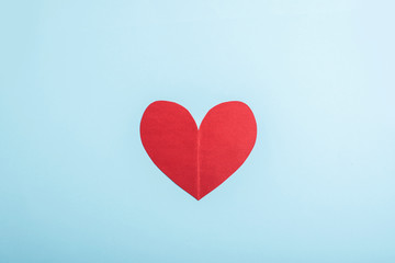 Fototapeta na wymiar A red heart on a light blue background