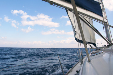 Yacht sailboat sailing in the deep blue ocean