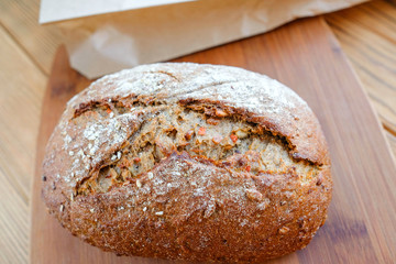 Carrot bread on a cutting board. Uncut loaf of bread. Home-made, eco-friendly product