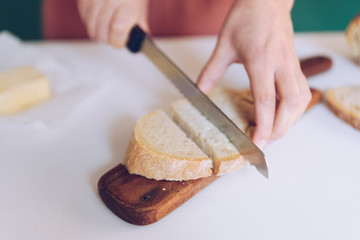 Woman cutting bread at  kitchen