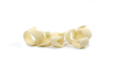 White Chocolate Curls Isolated On White Background. Group of chocolate shavings. Chocolate roll.