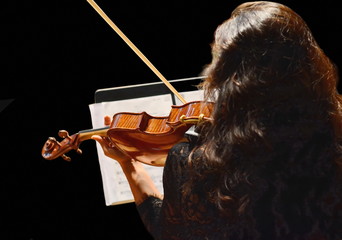 Young woman playing the violin. Isolated on black background. Copyspace.