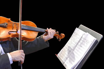 Musician play violin on dark background, close up