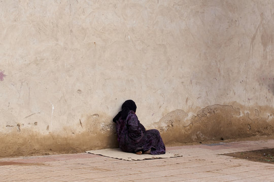 Veiled Poor Old Woman Sitting By A Wall Morocco