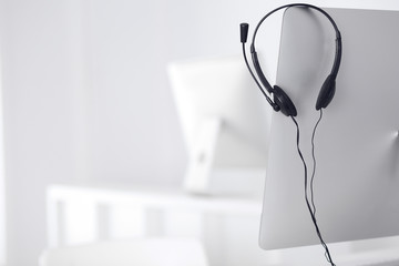 Call center and communication support, customer service help desk. VOIP headset on laptop computer