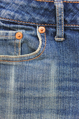 Jeans front pocket view, light blue fabric design with metal rivet and seams. Casual jean clothes detail, men's and women's bottoms close up vertical top view