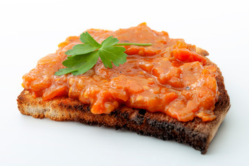 Traditional food from Romania concept with vegetable spread (Romanian: zacusca) on one single slice...