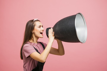 young activist shouts into a megaphone, a young girl in a jumpsuit