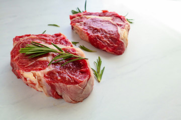 Tasty fresh beef steaks on light background