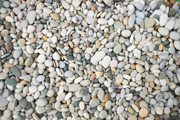 Colorful pebbles background. Stones on the beach. Pebbles texture.
