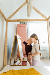 
Sisters play together in their large, sunny and bright room. They do not leave the house in self-isolation mode in an epidemic. Girls do their homework. Kids play and smile. Supporting each other
