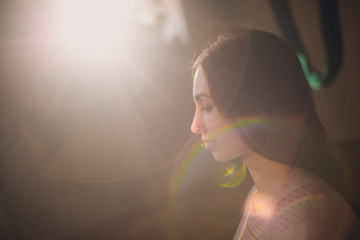 Stay home. Hatha yoga concept. Woman practicing yoga in home with rainbow.