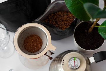 White background, flower in pot, strong black natural coffee in glassware prepared by alternative...