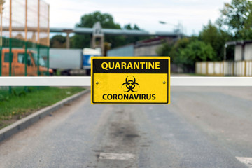 automatic barrier with a Coronavirus Warning sign, Covid-19 containment concept