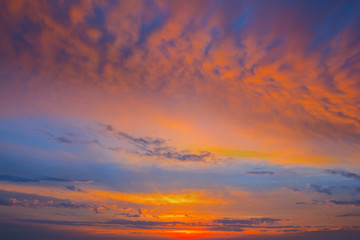 Naklejka na ściany i meble dramatic sunset over a cloudy sky, outdoor background
