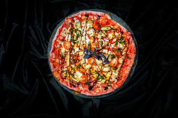 Tasty pizza on black background. Top view of hot pizza.